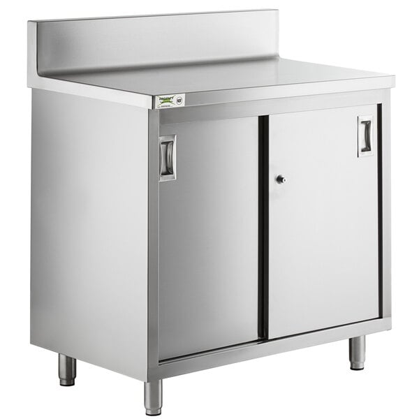 A Regency stainless steel enclosed base table with sliding doors.