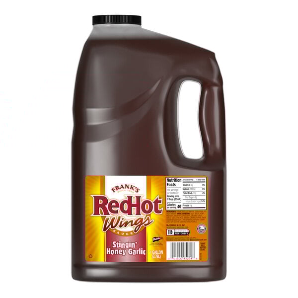 A 1-gallon jug of Frank's RedHot Stingin' Honey Garlic Wing Sauce.