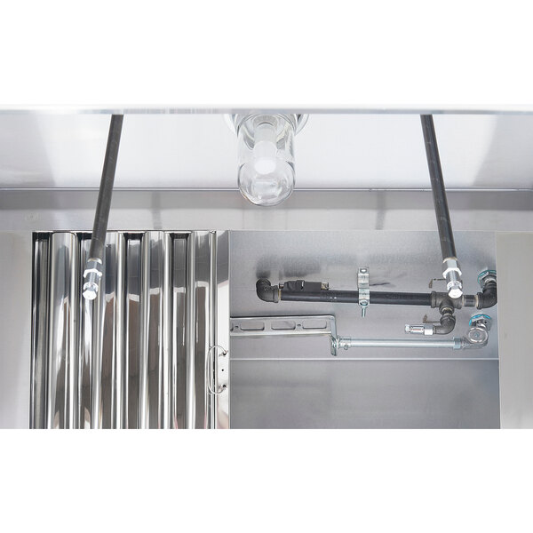 The Halifax Type 1 Concession Trailer / Food Truck Hood System with Fire Suppression with pipes and a metal surface.