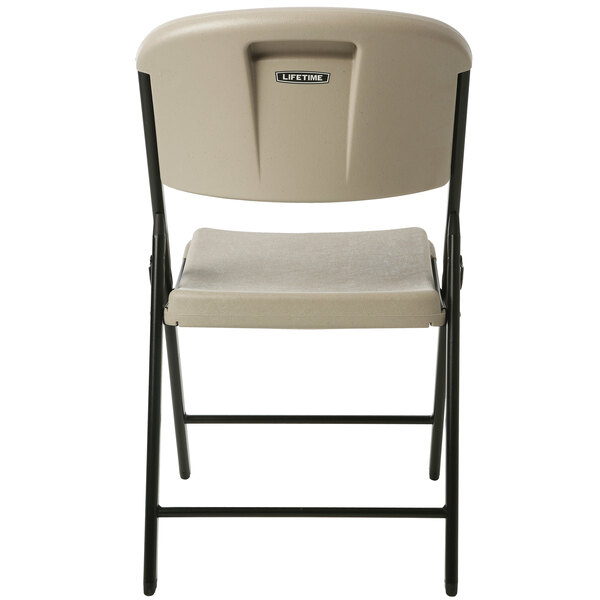 A back view of a Lifetime putty folding chair with a black seat.