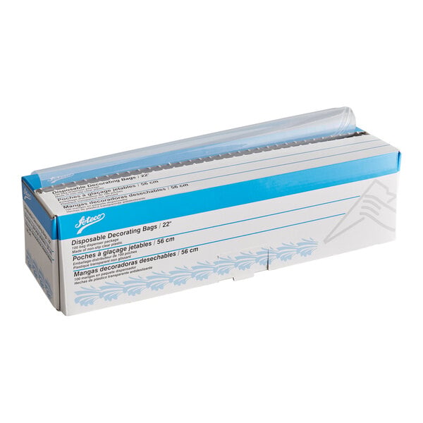 A box containing a roll of clear disposable decorating bags with a perforated opening for easy dispensing.