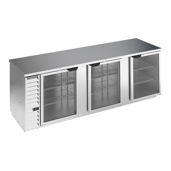 A stainless steel counter height back bar refrigerator with three glass doors and interior shelving.