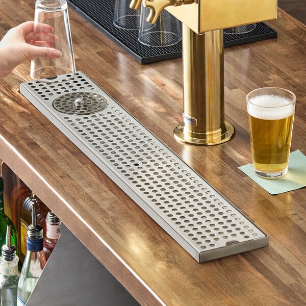 A stainless steel surface mount beer drip tray with a built-in glass rinser, measuring 30 inches by 5 inches.