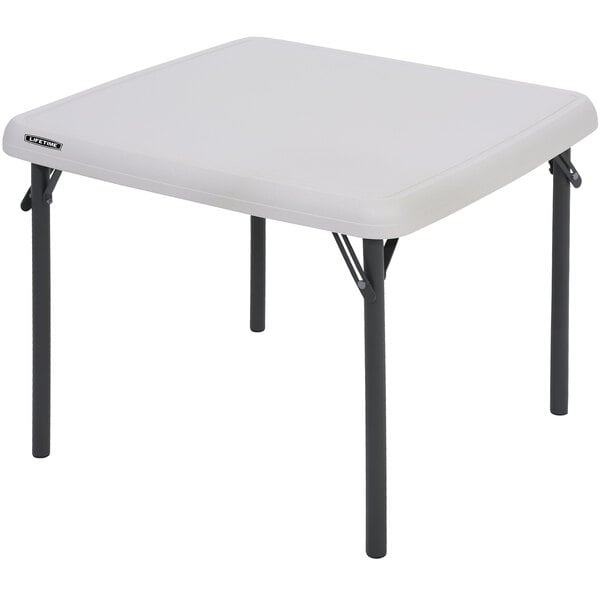 A white square table with black legs.