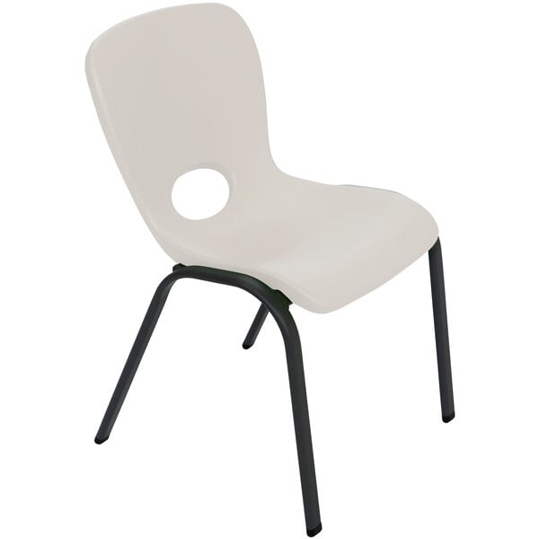 A white plastic Lifetime children's stacking chair with black legs.