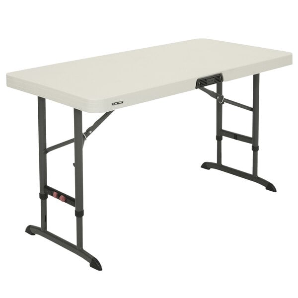 A white rectangular Lifetime plastic folding table with black legs.