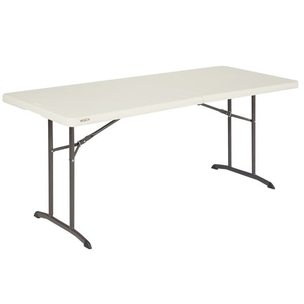 A white rectangular Lifetime plastic fold-in-half table with metal legs.