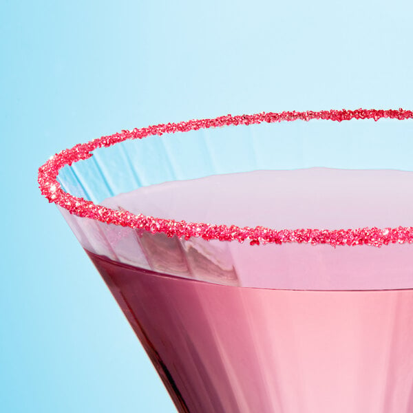 A pink cocktail with Adourne pink sanding sugar sprinkled on top.