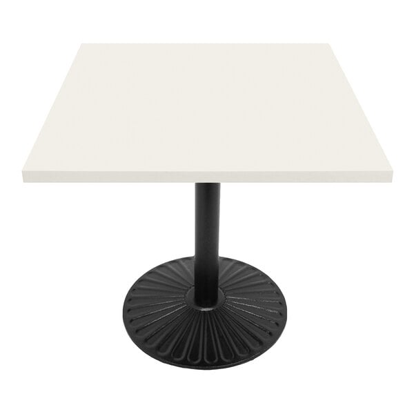 An Art Marble Furniture white quartz table top on a black table with black base.