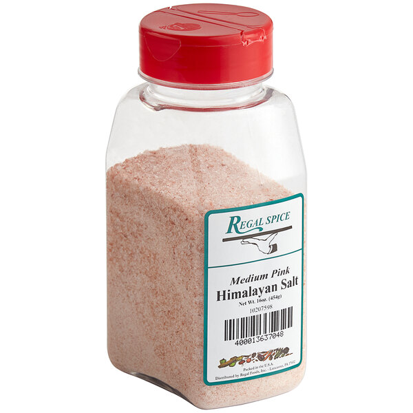 A jar of Regal Medium Grain Pink Himalayan Salt with a red lid.