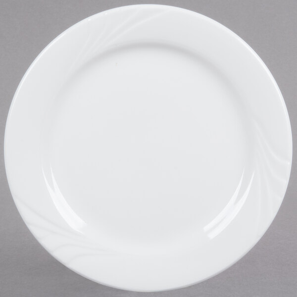 A Tuxton bright white china plate with a swirl design on the rim.