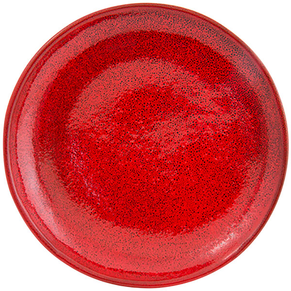 A red porcelain plate with black specks.