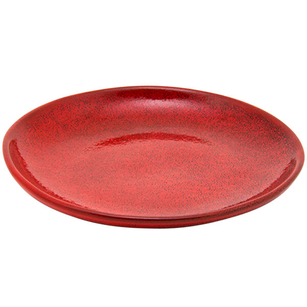 A red porcelain plate with a small rim and speckled surface.
