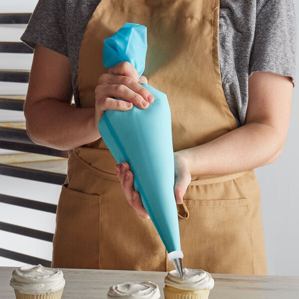 Baker using a thermoplastic polyurethane pastry bag to decorate cupcakes