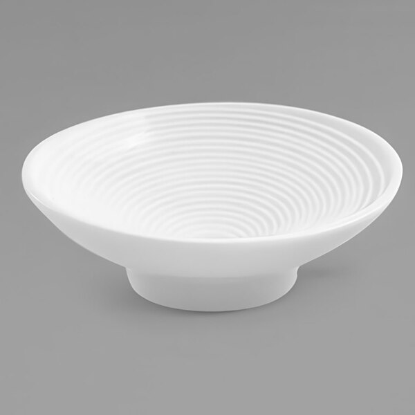 A white bowl with a spiral design on it.