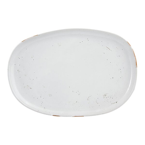 An oval white porcelain plate with a slightly rustic, worn finish.