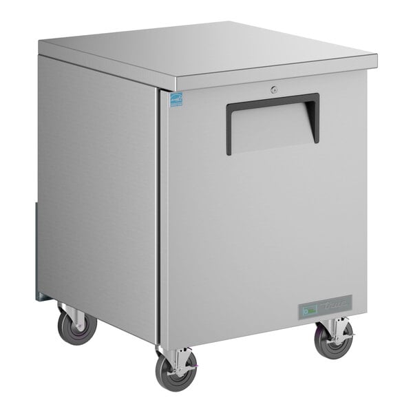 A silver True undercounter refrigerator with a black handle.