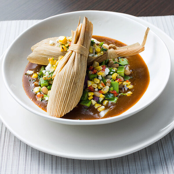 a bowl of food with a tamale