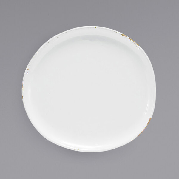 A white Front of the House Artefact porcelain plate with gold trim.