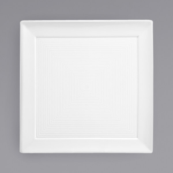 A white square porcelain plate with a spiral pattern.