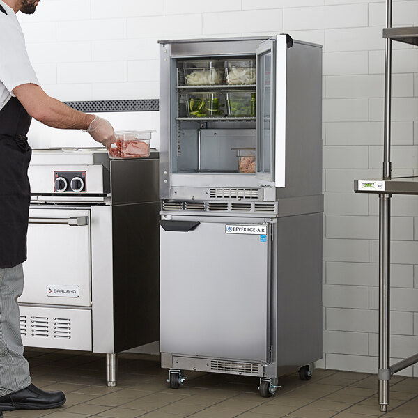 A man standing in front of a Beverage-Air double stacked shallow depth undercounter refrigerator and freezer.