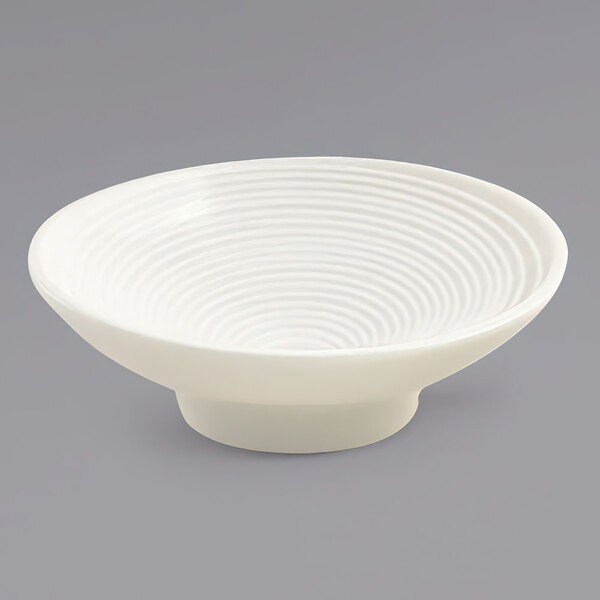 A white Front of the House ramekin with a spiral pattern.