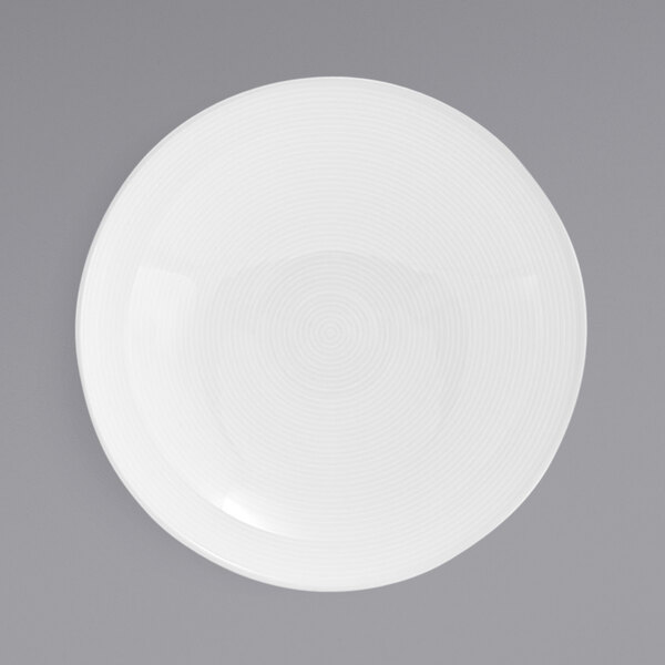 A white round porcelain bowl with a spiral design on it.