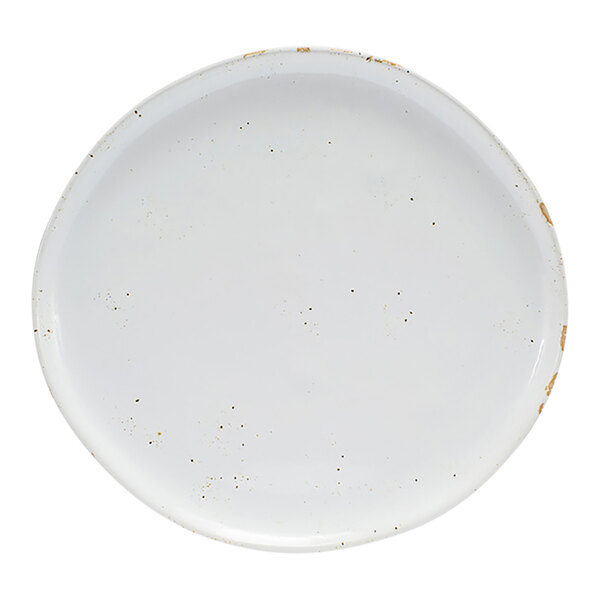 A round, white porcelain plate with subtle speckled detailing and a slightly rustic finish.