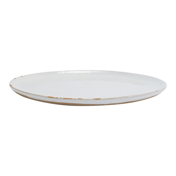 A round, white porcelain plate with a slightly rustic, worn edge.