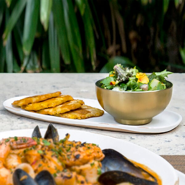 A plate of food with a bowl of salad on it.