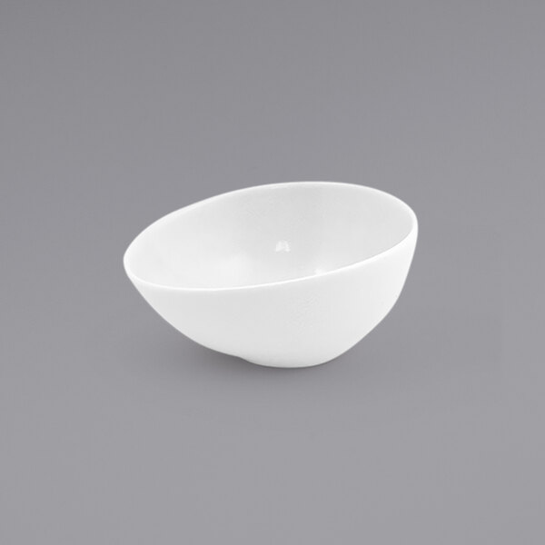 A Front of the House superwhite porcelain ramekin on a gray background.