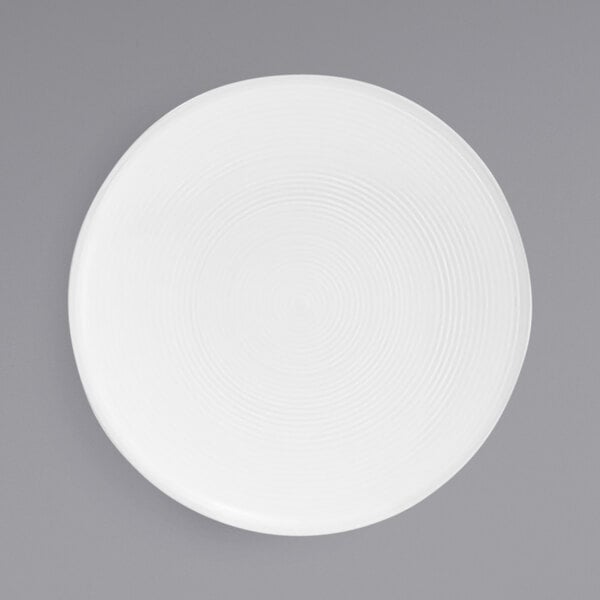 A white plate with spiral lines on it.