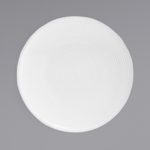 A white porcelain plate with a spiral pattern.