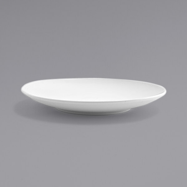 A white plate with a spiral rim on a gray background.