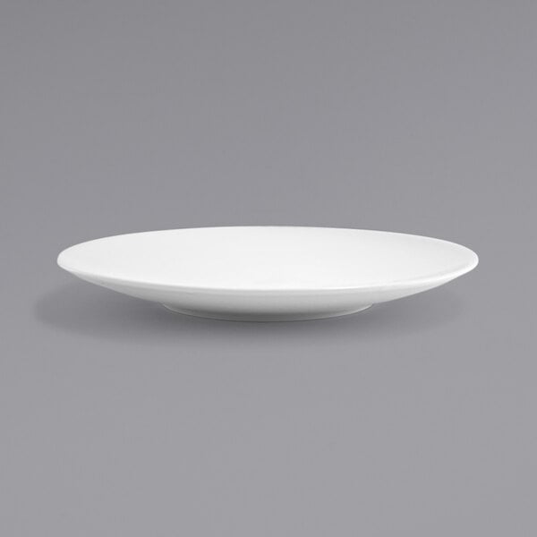 A close up of a white Front of the House Spiral porcelain plate with a rim.