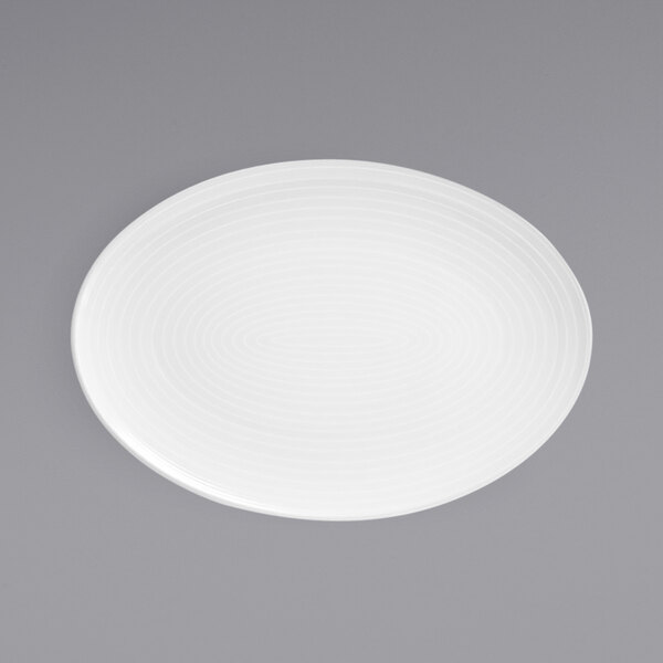 A white porcelain oval plate with a spiral pattern.