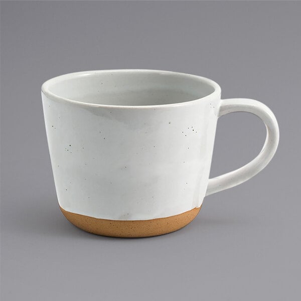 A white Front of the House Artefact mug with a brown handle.