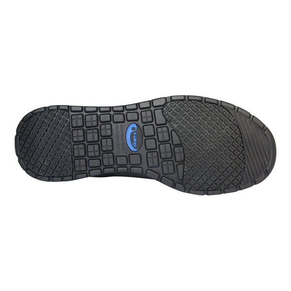 The image shows the black rubber outsole of a shoe with a textured, grid-like tread pattern and a blue oval logo in the center.