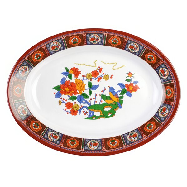 A Thunder Group oval melamine platter with a colorful peacock and floral design.