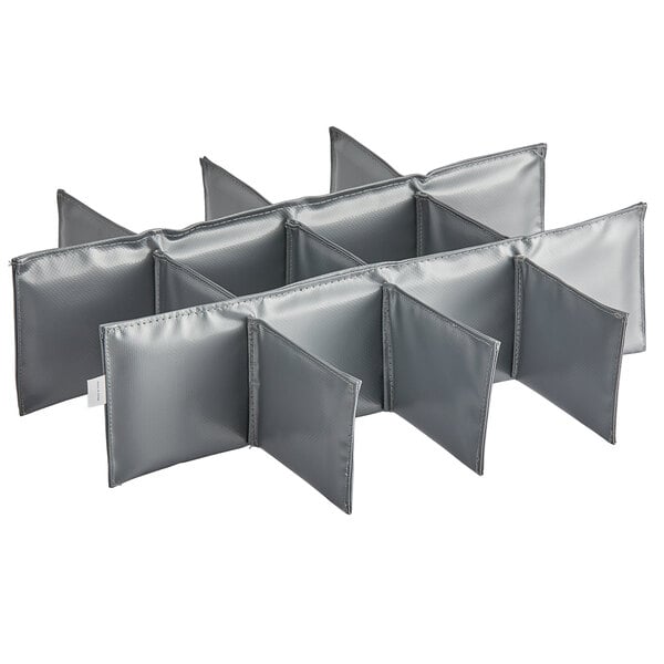 A set of four grey plastic dividers with six compartments each.