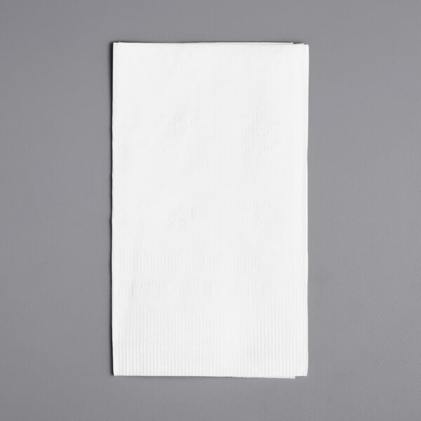 A white Choice 3-ply dinner napkin on a gray surface.
