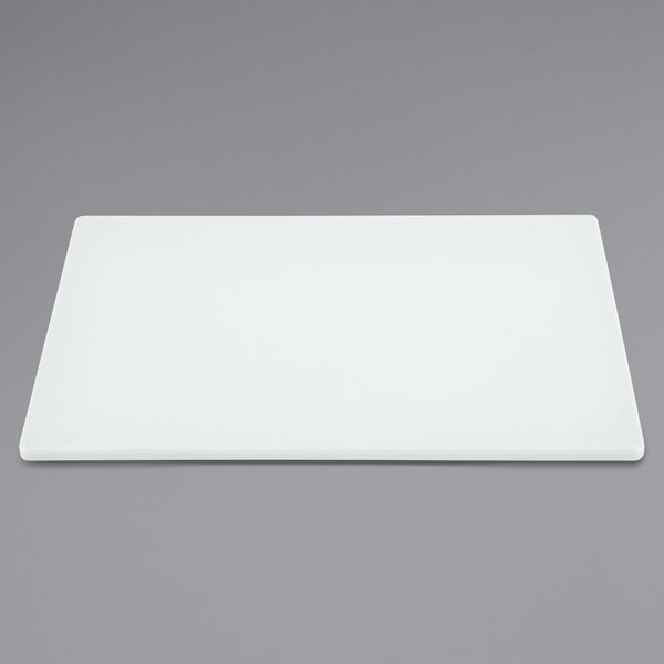 A white rectangular Vollrath cutting board.