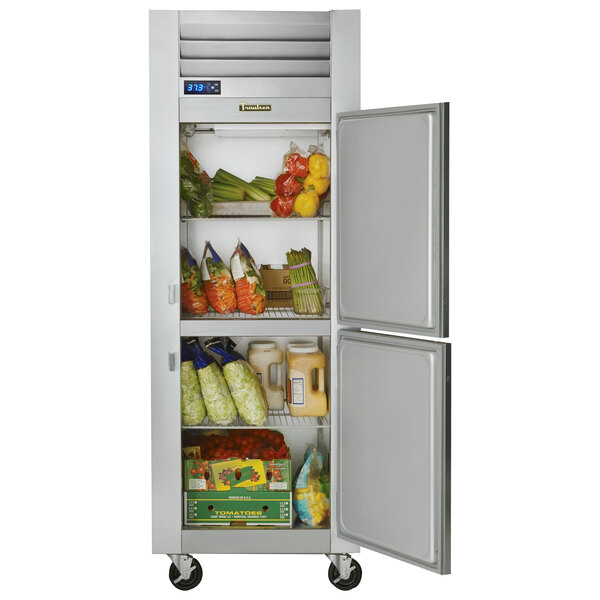 A silver Traulsen G Series reach-in refrigerator with right hinged doors open and full of food.