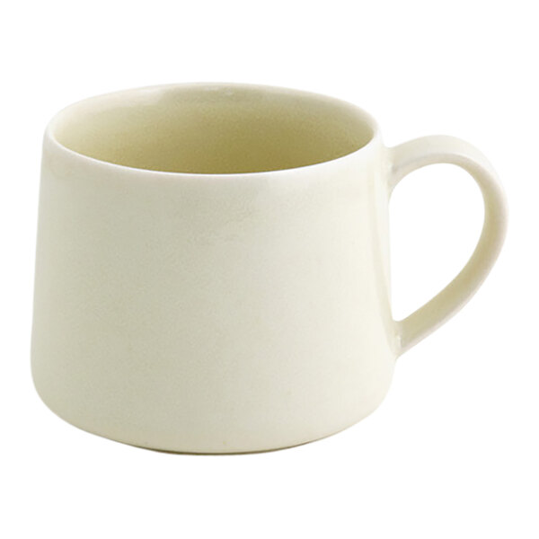 A small, vanilla-colored porcelain cup with a handle.
