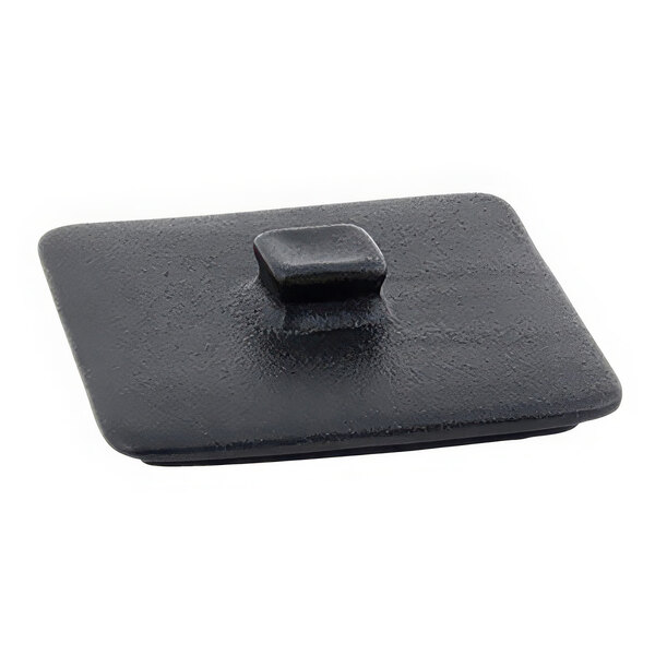 A close up of a black square Front of the House Kiln stoneware lid with a square knob.