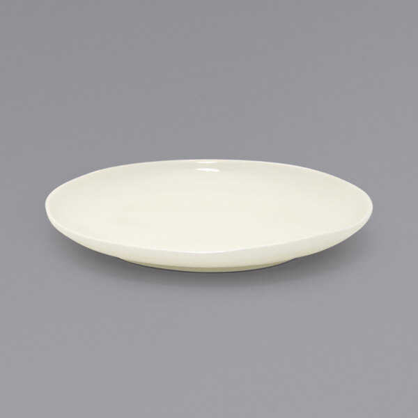 A white Front of the House Kiln porcelain plate with a small rim.