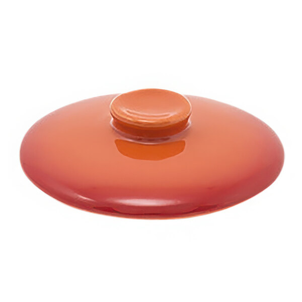 A red Kiln stoneware lid with a small orange button on top.