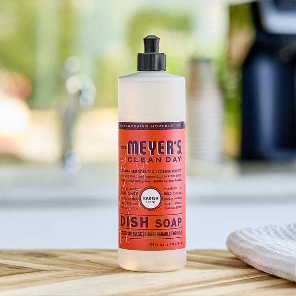 A Mrs. Meyer's Clean Day Radish Scented dish soap bottle on a counter.