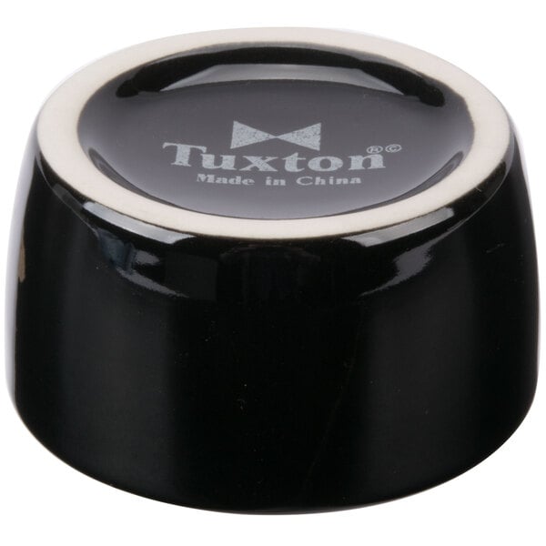 A Tuxton black china ramekin on a table.