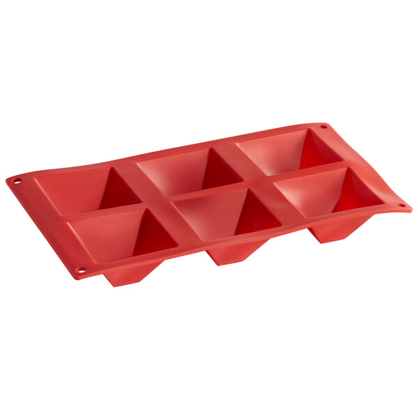 a red silicone mold with holes